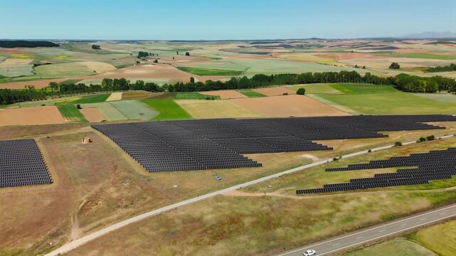 Solar power array bordering patchwork farmland in Avila Spain