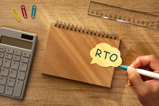 RTO sticky note on spiral notebook surrounded by business tools &mdash; ideal eye-catcher for IT disaster recovery articles