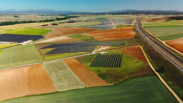 High-altitude panorama of solar fields and highway in Avila
