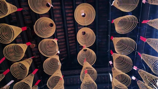 Hanging burning incense coils inside a traditional Chinese temple in Cholon, District 5, Ho Chi Minh City, Vietnam