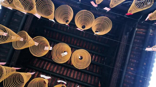 Hanging burning incense coils inside a traditional Chinese temple in Cholon, District 5, Ho Chi Minh City, Vietnam