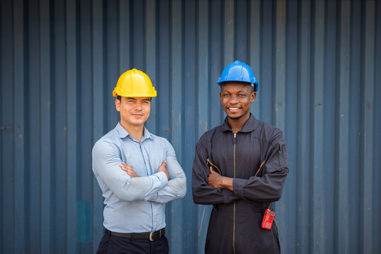 Diverse Industrial Workers Wearing Safety Helmets Standing Together at Construction Worksite