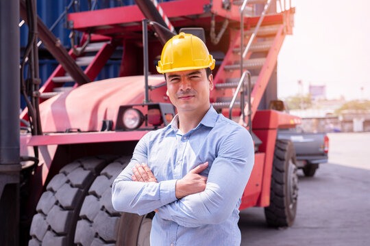 Confident Construction Engineer Wearing Safety Helmet Standing Beside Heavy Industrial Machinery
