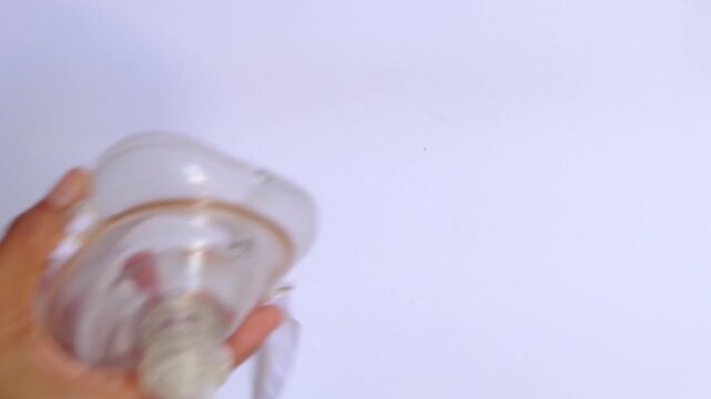 Close up of hands holding a CPR pocket mask with one-way valve, emergency medical equipment for rescue breathing