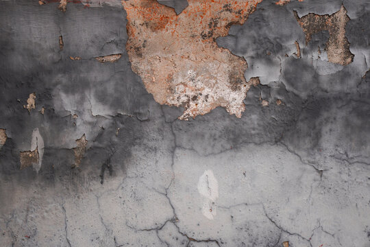Peeling Paint on Textured Concrete Wall with Cracks