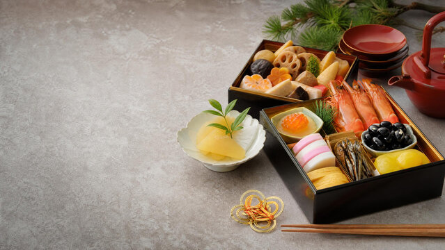 Japanese New Year osechi food in traditional boxes with copy space