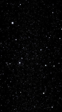A vertical view of the deep dark night sky, sparkling with numerous bright stars, constellations, and distant galaxies in the vast universe.