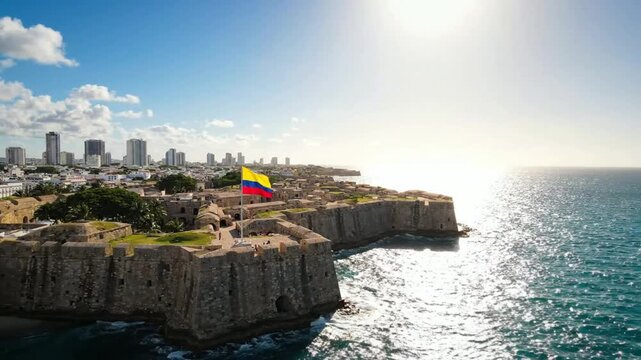 Colombian flag waving over castillo san felipe de barajas in cartagena, caribbean coast south america