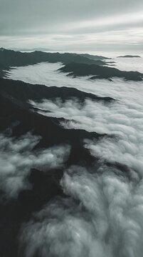 Misty Sea of Clouds Over Mountain Range at Sunrise or Sunset