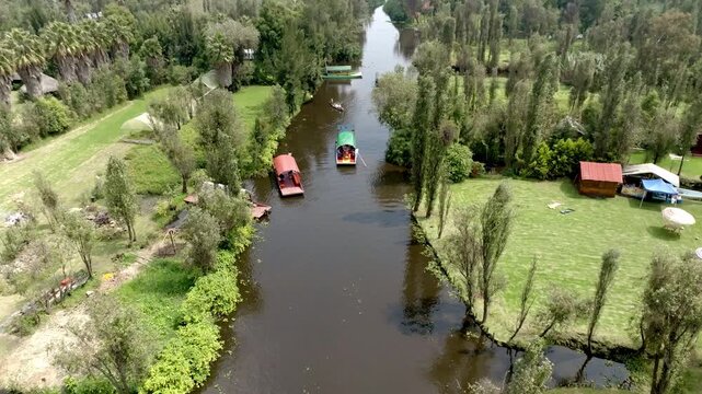 Aerial view of colorful trajineras boats and canals on a pier in Xochimilco in Mexico City