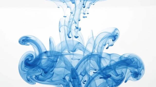 Stunning abstract image of blue ink dissolving and swirling in clear water creating graceful fluid motion