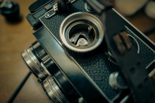 A close‑up of a vintage TLR film camera fitted with a Rolleinar close‑up lens set on both twin lenses.