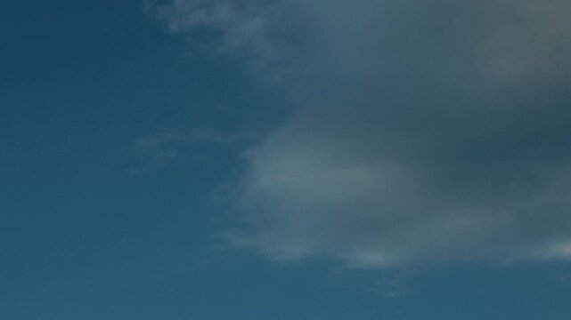 Blue sky with thin, widespread gray clouds
