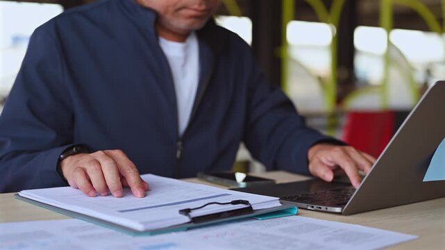 Corporate accountant conducts risk analysis indoors, managing finance spreadsheet paperwork, executing detailed performance analysis alongside corporate finance audit report analysis.