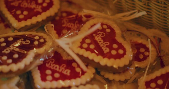 Basket filled with beautifully decorated heart shaped gingerbread cookies with text Praha inside Prague Czech Republic