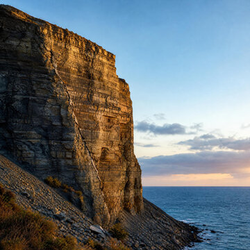 Towering coastal cliff with visible diagonal fault