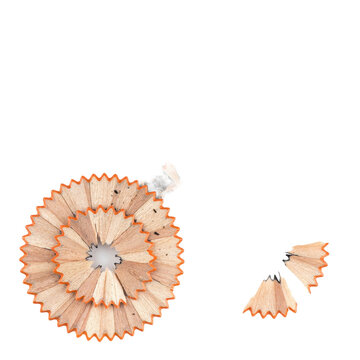 Spiral arrangement of wooden pencil shavings with graphite dust particles on a white surface isolated on a transparent background