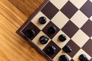 Chess game with chess pieces on a chessboard. Strategic board game concept representing intelligence, planning, competition, tactics and logical thinking. © mahmoud