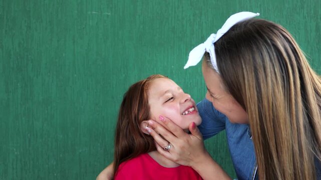 Happy Hispanic mother and daughter having tender moment together - Mom and child love relationship
