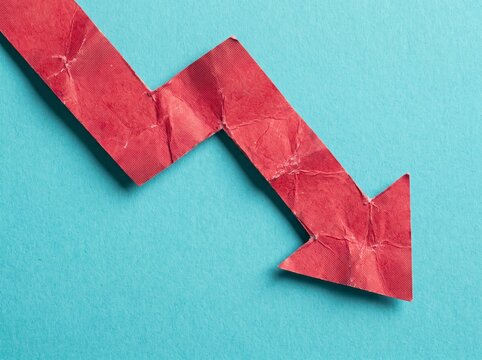 Crumpled Red Arrow Pointing Down Representing Economic Decline and Financial Recession