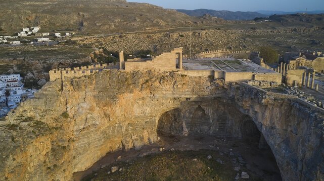 Drone shot, first morning light, Lindos, Acropolis of Lindos, Temple of Athena Lindia, Ancient theatre and ruins on cliffs with sweeping views of the surrounding landscape, Archaeological site, Lindos, Rhodes, Dodecanese, Greek Islands, Greece