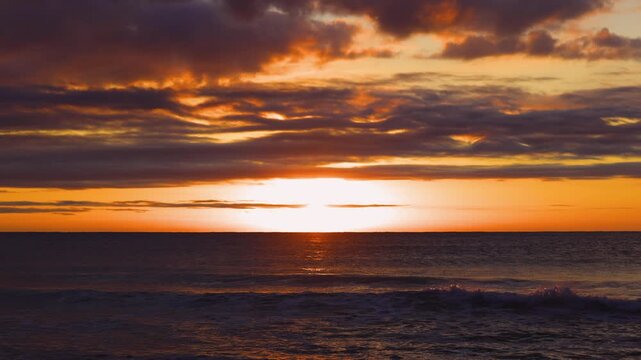 Dramatic Orange Sunset Over Ocean Horizon With Sun Setting cinematic