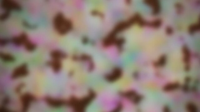 Abstract background featuring a soft blur of pastel colors and dark shapes