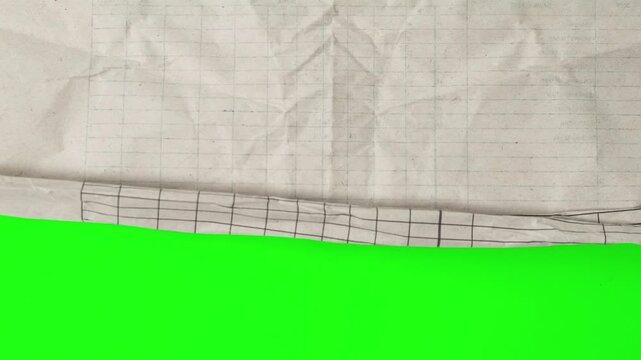 Crumpled grid paper scrolling down and up transition on green screen stop motion, paper wipe effects, overlay elements, paper reveals, retro video aesthetics, and educational video projects.