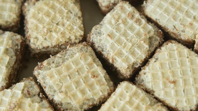 Close up of stacked square wafer biscuits with creamy filling