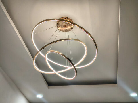Modern circular ring LED chandelier hanging from indoor ceiling.