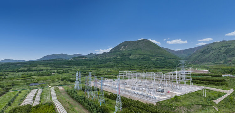 Large High Voltage Substation in Green Mountain Valley Landscape