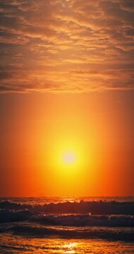 Golden Sunrise Over Calm Ocean Horizon With Sunlight on the waves and sand