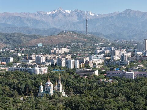 Almaty cityscape with Kok Tobe TV tower, Ascension Cathedral and snow-capped Trans-Ili Alatau mountains, Kazakhstan. g.