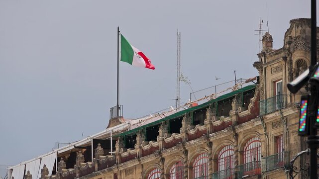 Mexican Flag Waving Above Historic Building Zocalo Mexico City Overcast Sky
