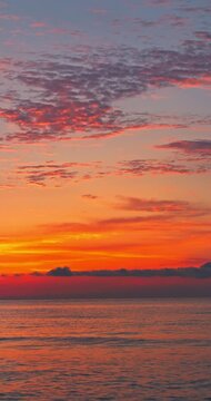 Scenic Sunrise Over Ocean Waves Crashing Toward the Sea Shore and beach vertical landscape