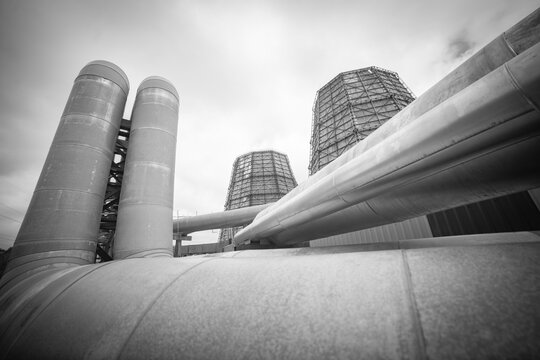  Industrial power station cooling towers and massive pipelines monochrome landscape background with copy space