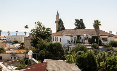 Obraz premium Larnaca, Cyprus, August 30, 2026 : A view from a window onto the rooftops of houses in the old historical district of Larnaca in Cyprus