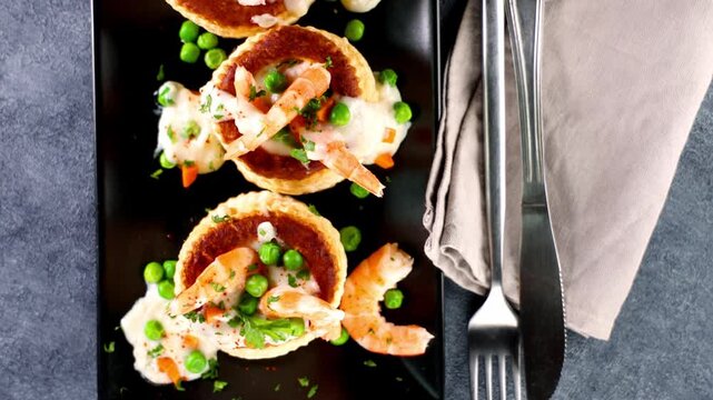elegant shrimp appetizer with peas and creamy sauce, fine dining- puff pastry, vol au vent