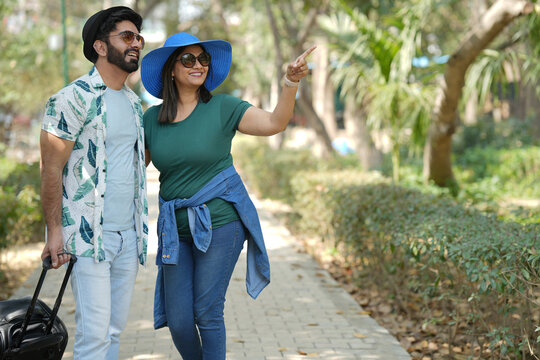 Portrait of Indian loving couple for travel adventure or urban tour and journey abroad for honeymoon. Man, woman and hug together with support for romantic vacation holiday. Tour Romantic couple.