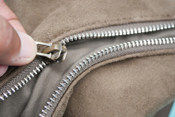 fixing the broken zipper of a bag  © Towfiqu Barbhuiya 