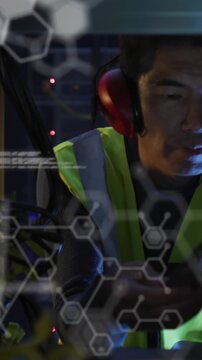 Animation of data processing against asian male engineer using digital tablet working at server room