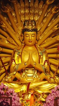 Sculpture of multi-armed god in Chinese Buddhists temple, religion and faith. Thousand-armed Guanyin, Bodhisattva, praying in pagoda, taoism and chinese folk religion, travel in china, Asian culture
