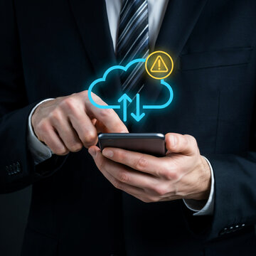 Businessman working on a smartphone displaying cloud synchronization and system warning icons.