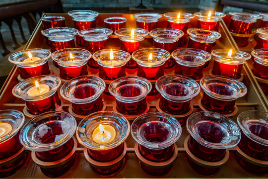Tea lights burning in memory of a loved one in a church setting