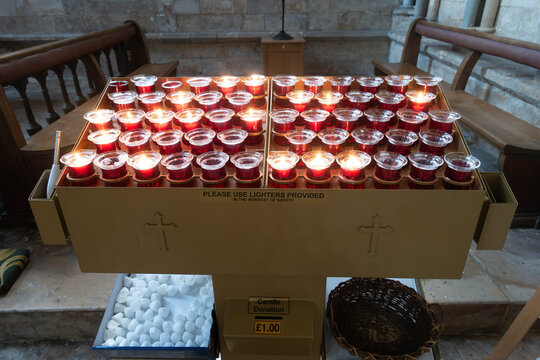Tea lights burning in memory of a loved one in a church setting