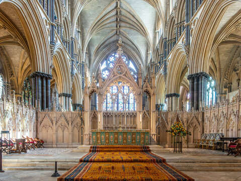The High Altar at Lincoln Cathedral, with carpeted steps and an ornate, high ceiling
