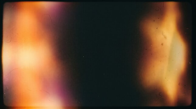 Vintage film light leak overlay with dust and scratches on dark background, featuring nostalgic retro aesthetic and warm analog burn effect for video editing and cinematic photo filter design.