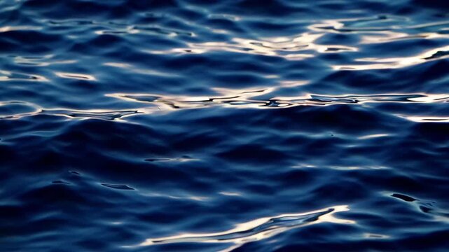 Close up ocean waves water texture with shimmering natural surface