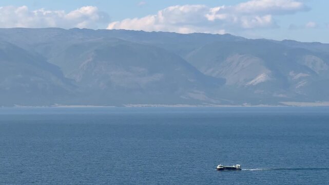 Lake Baikal in summer. Video of tourists traveling on blue water of the Small Sea on a passenger hovercraft from the village of Khuzhir along Olkhon Island on summer day