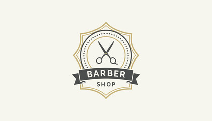 Fototapeta premium Vintage barber shop emblem with retro scissors symbol inside a shield badge over a warm cream colored background.